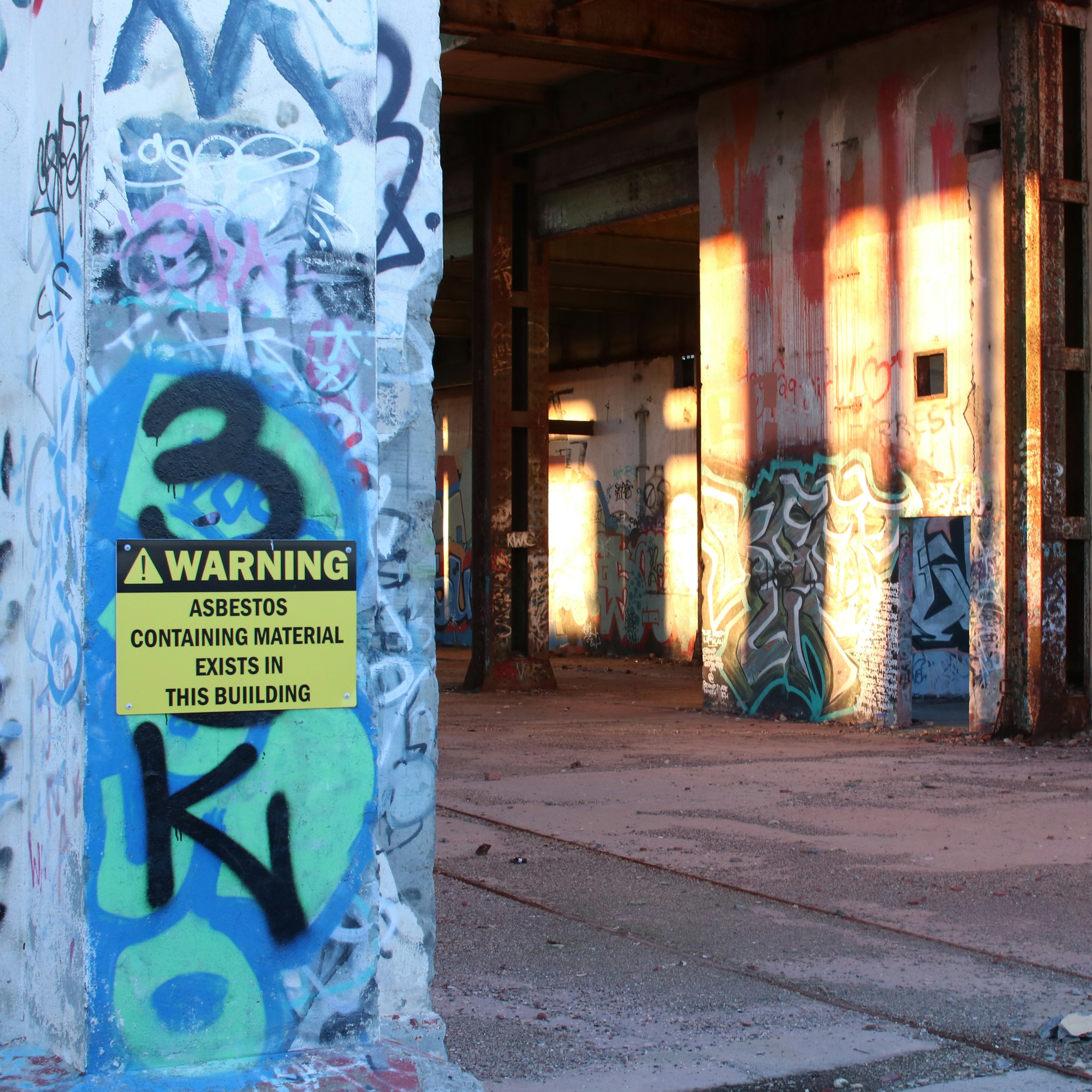 photo of work site with asbestos warning sign